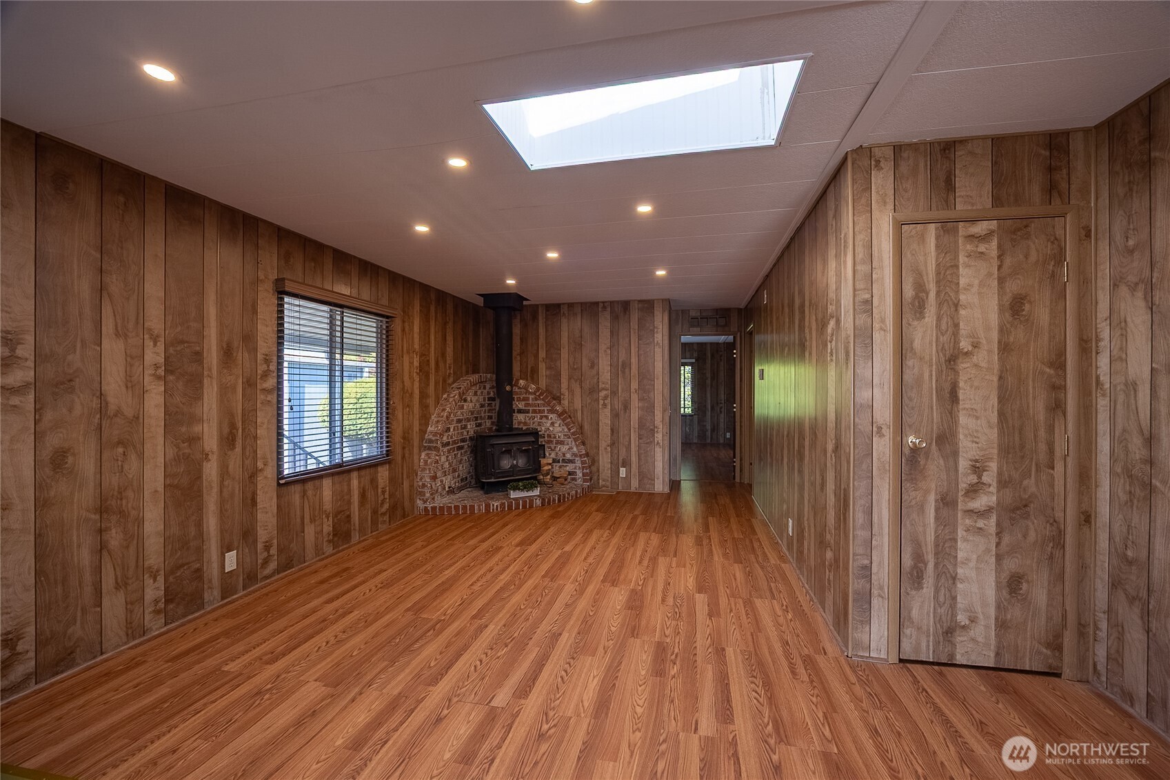 Dining room and Family Room with Wood Burning Stove and Skylight.