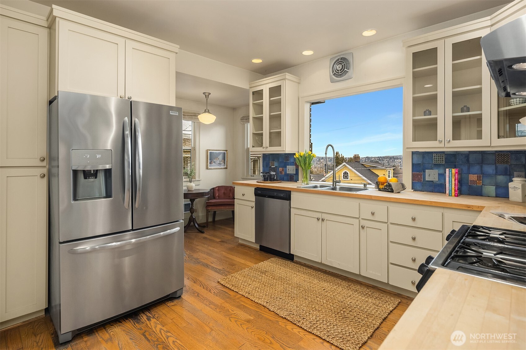 Stainless steel appliances and gas range complete this kitchen.