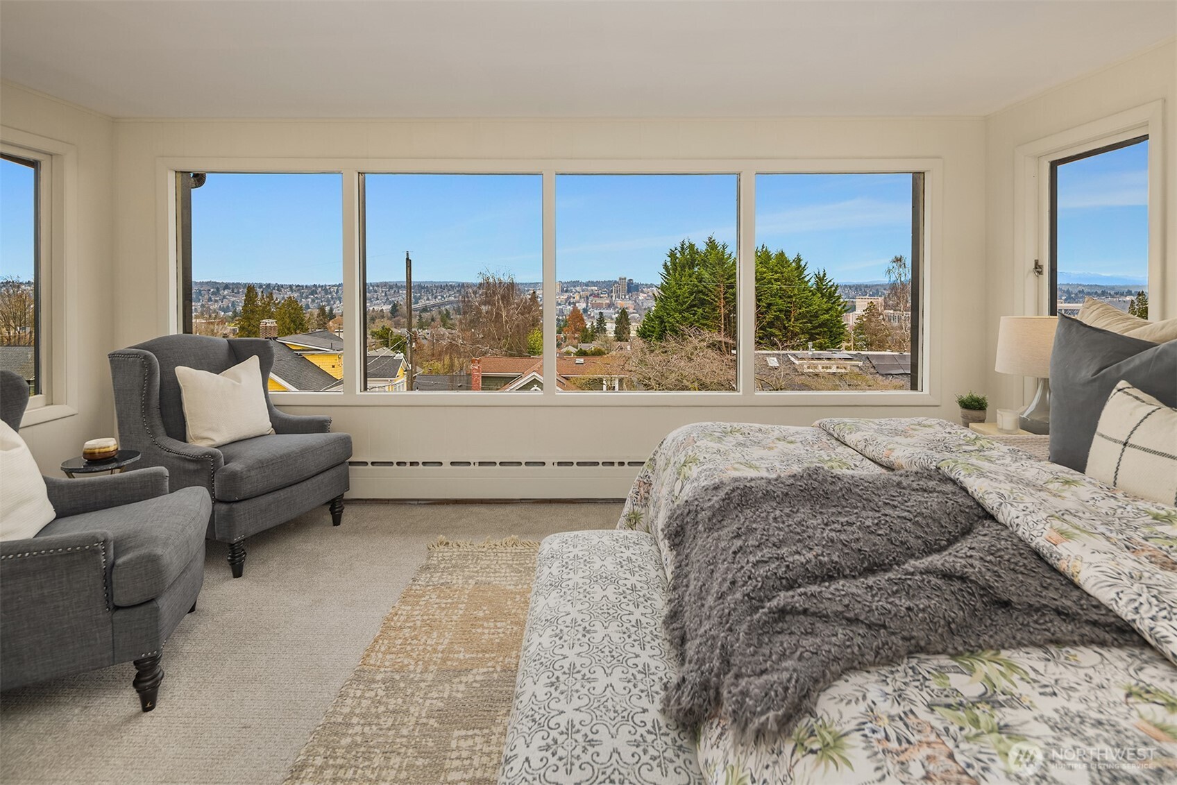 Mountain views from primary bedroom with seating area.