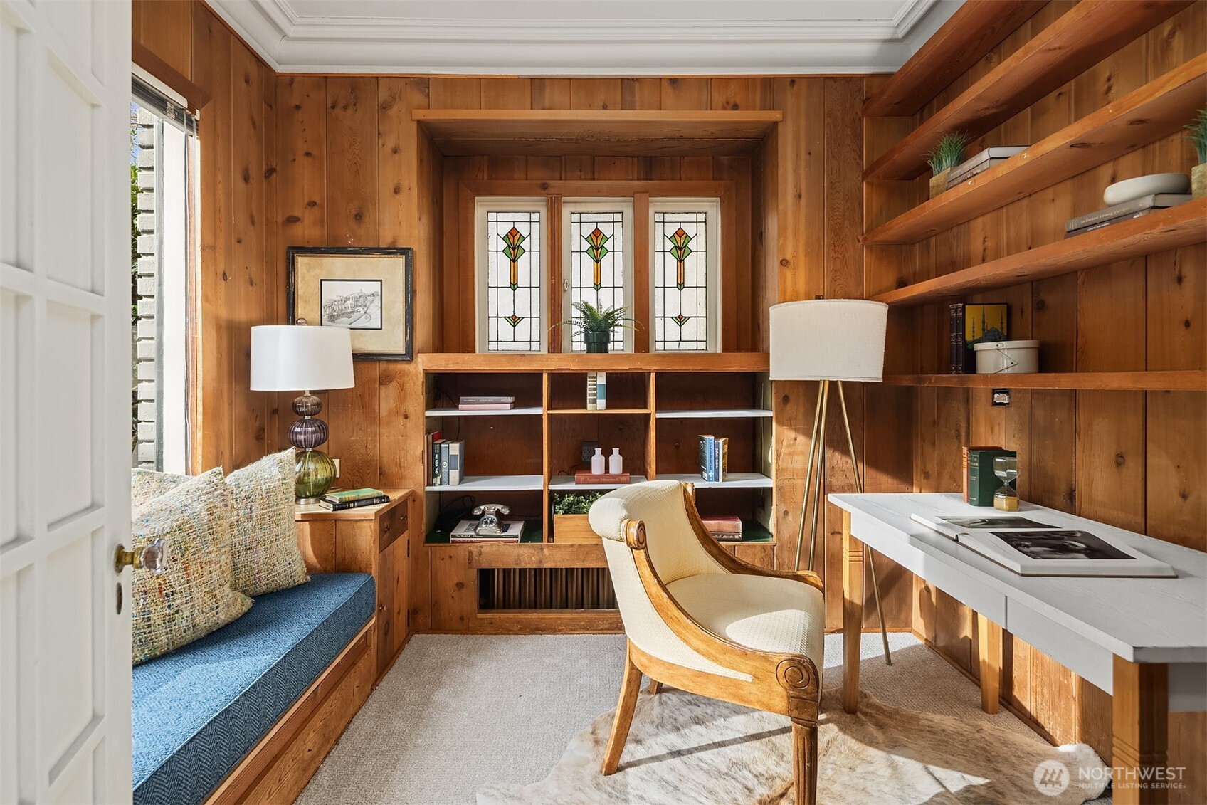 Den, library or office right off the main entry has classic details and stainled glass windows.