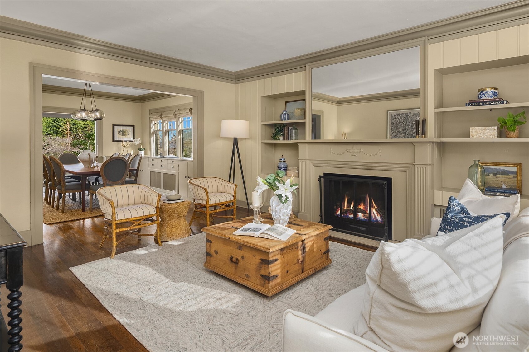 Cozy fireplace and built in book cases with shutters makes this desirable living room.