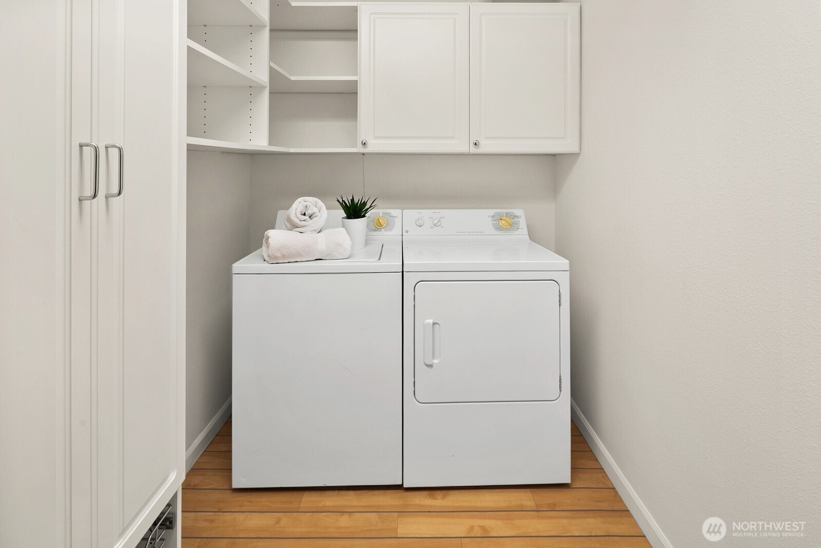 In-unit laundry and storage room with custom closet system by Closet by Design