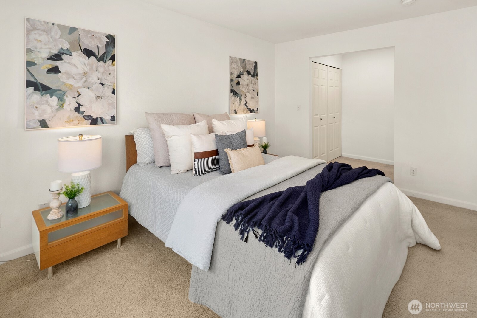 Spacious primary bedroom with bay window and dedicated custom closet area