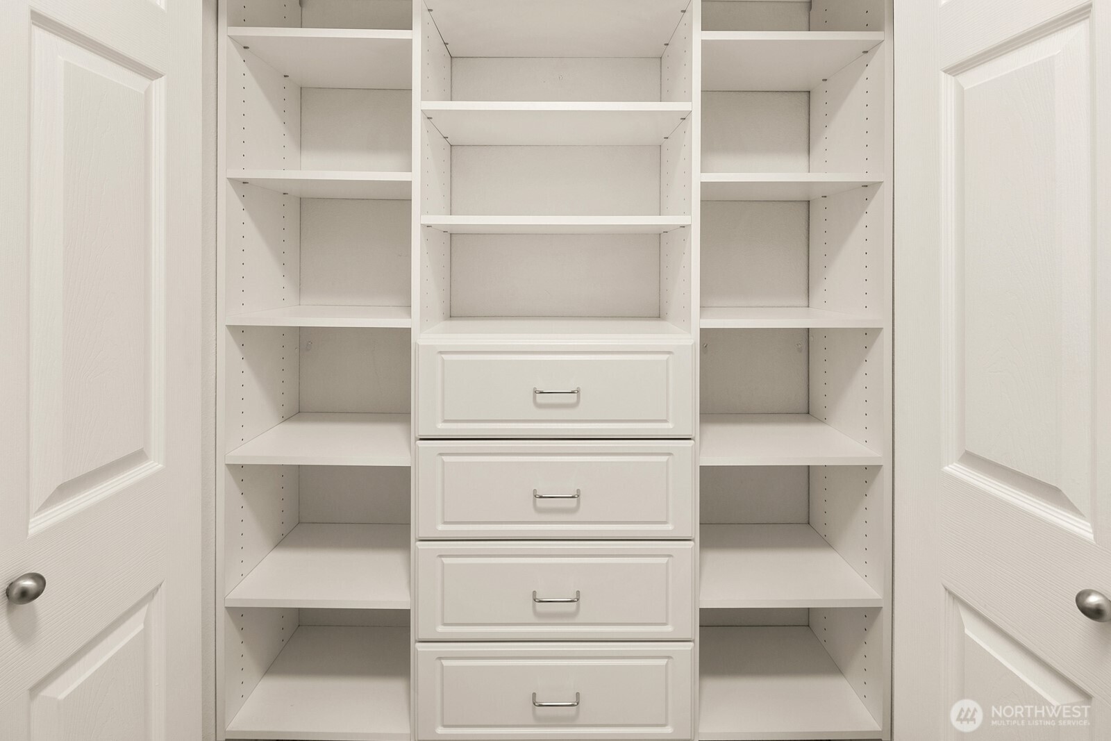 Custom closet system by Closet by Design in primary bedroom