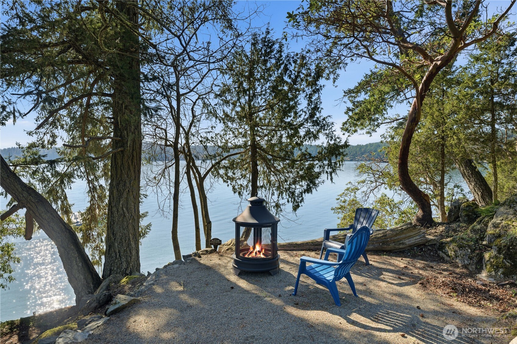 Waterfront relaxation with two firepit/entertainment areas: this one tucked into the trees offering shade