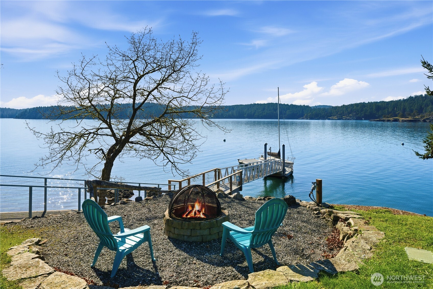 Sunny waterfront firepit ideal for crisp spring days and evening gatherings