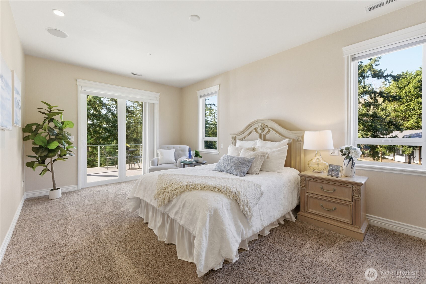 This main-floor bedroom, complete with its own 3/4 ensuite, large closet and private toilet, offers the versatility to serve as a second primary suite. Sliding doors open to the north deck and wide, unobstructed views