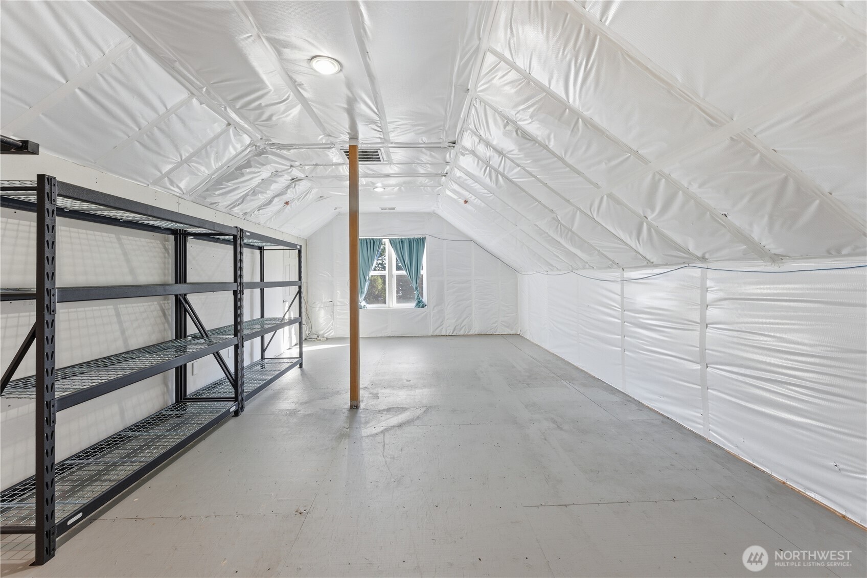 The south bedroom suite is drywall-ready, with plumbing in place for a bathroom and framing for a large dormer. Behind the drywalled left wall lies extensive built-in storage