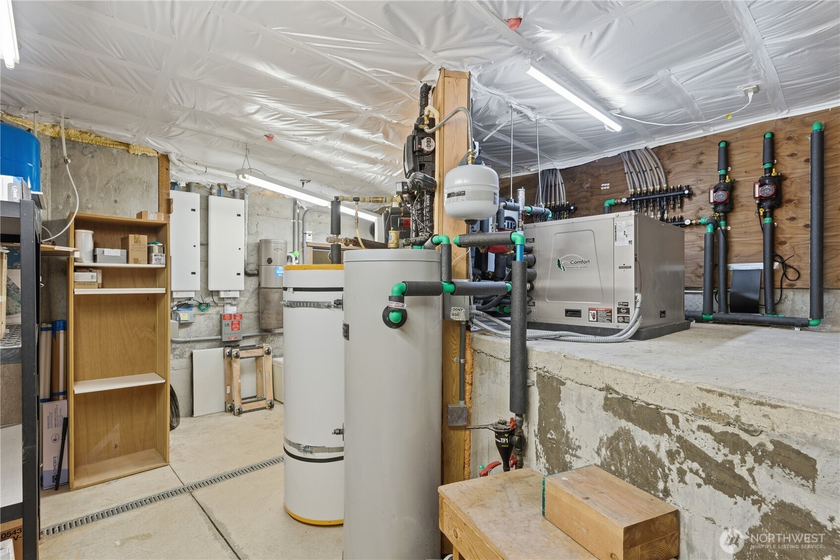 This organized mechanical space supports radiant heat, geothermal, solar heated water, potable water distribution and full electrical and communications systems, with layered redundancy for uninterrupted performance