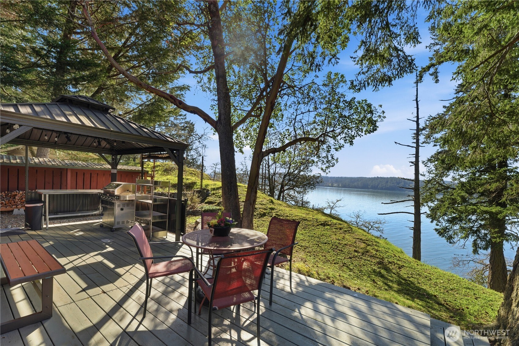 The deck and outdoor kitchen of Cottage #1 offer gorgeous views and an ideal setting for cooking, dining, and relaxing by the water