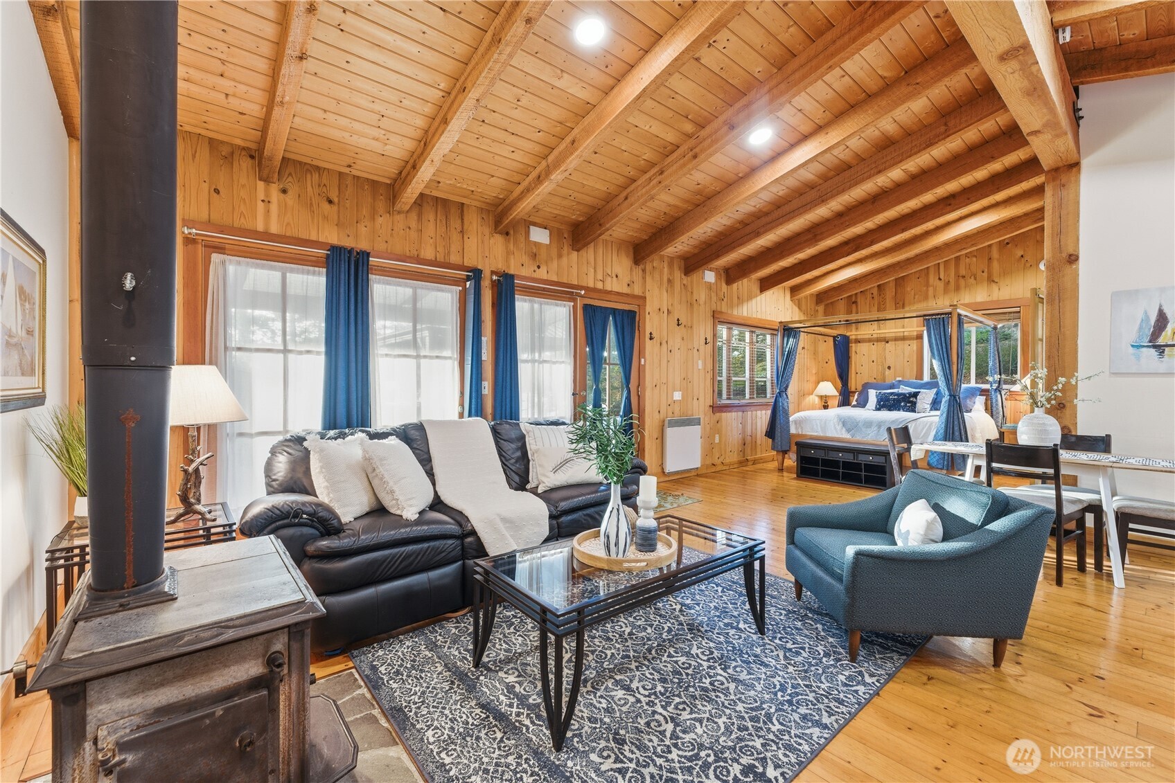 The main living area of Cottage #2 features a large king bed, a separate bedroom with bunk beds, a full kitchen, a full bathroom, and a dedicated storage area