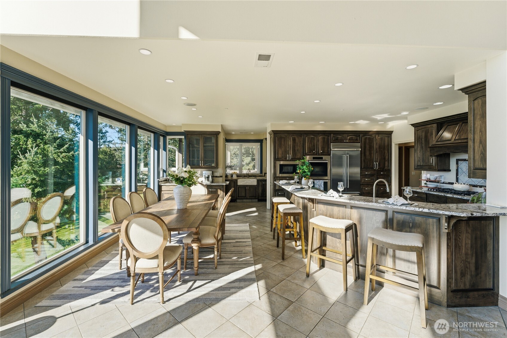 Kitchen and dining area with a clear sightline into the scullery, complemented by the home’s gorgeous radiant-heated tile flooring