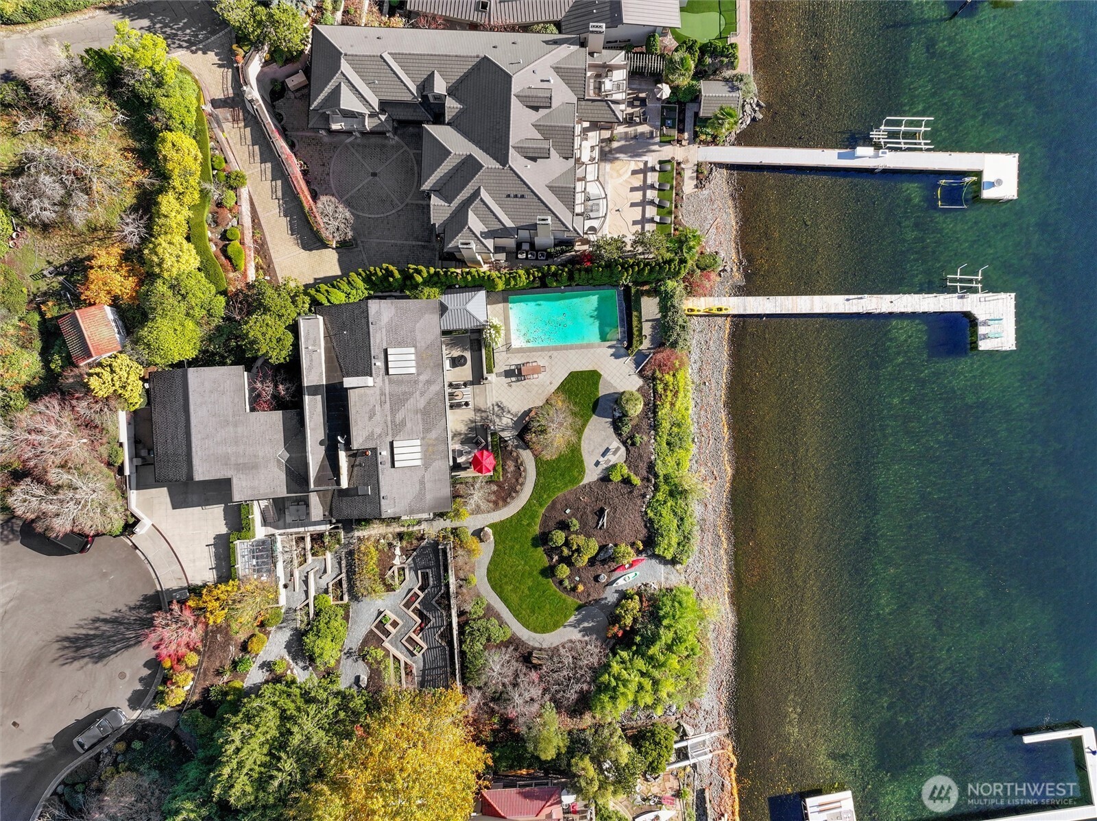 A truly magnificent and rare Lake Washington offering—this iconic southwest-facing waterfront estate spans two parcels at the end of a private gated lane, with an extraordinary 161 feet of no-bank shoreline and sweeping, panoramic views of the lake, Mount Rainier, city skylines, rose-colored sunsets, and endless maritime activity – it is ever-changing art at its finest