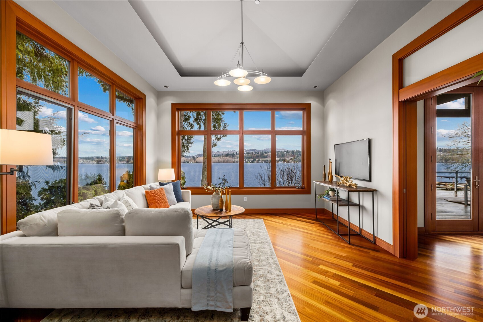 Chef’s kitchen with island seating, quartz countertops, custom cabinetry, and stainless steel appliances.