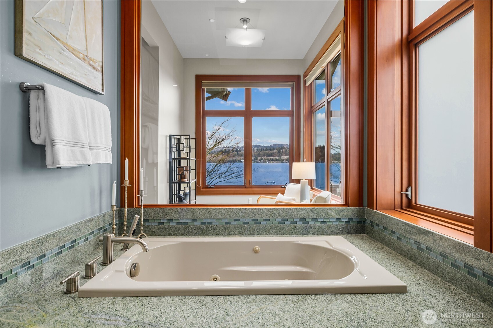 A space that feels like a spa—walk-in glass shower with pebble underfoot, layered tile, and a seamless connection back to the suite.