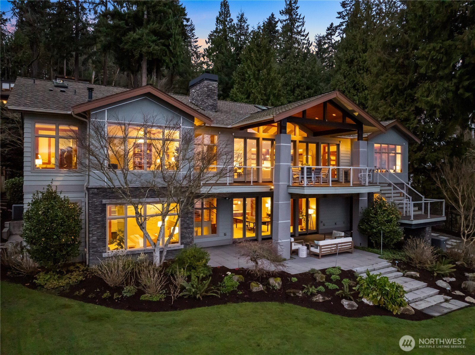 A striking Northwest contemporary set against lush natural surroundings—thoughtfully designed with expansive glass, layered outdoor spaces, and seamless indoor-outdoor living.