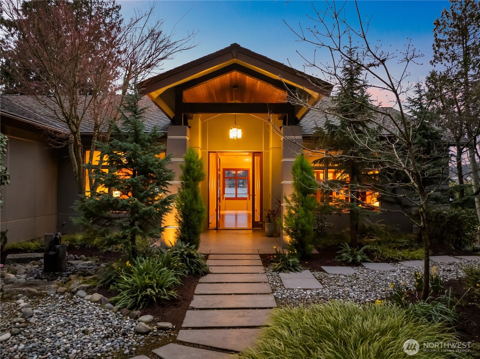 Inviting entry with custom fir door, covered front porch, and thoughtfully designed landscape approach.