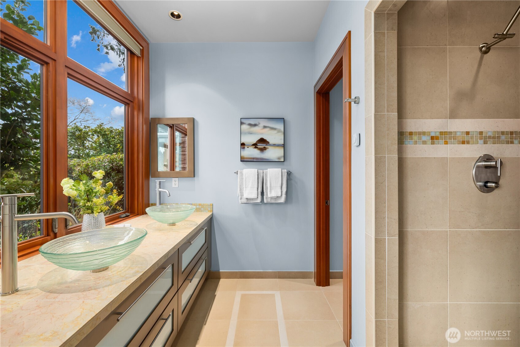 A seamless extension of the suite, this spa-inspired bath pairs sculptural glass vanities with serene garden and water views—bringing light, privacy, and a sense of calm to everyday routines.