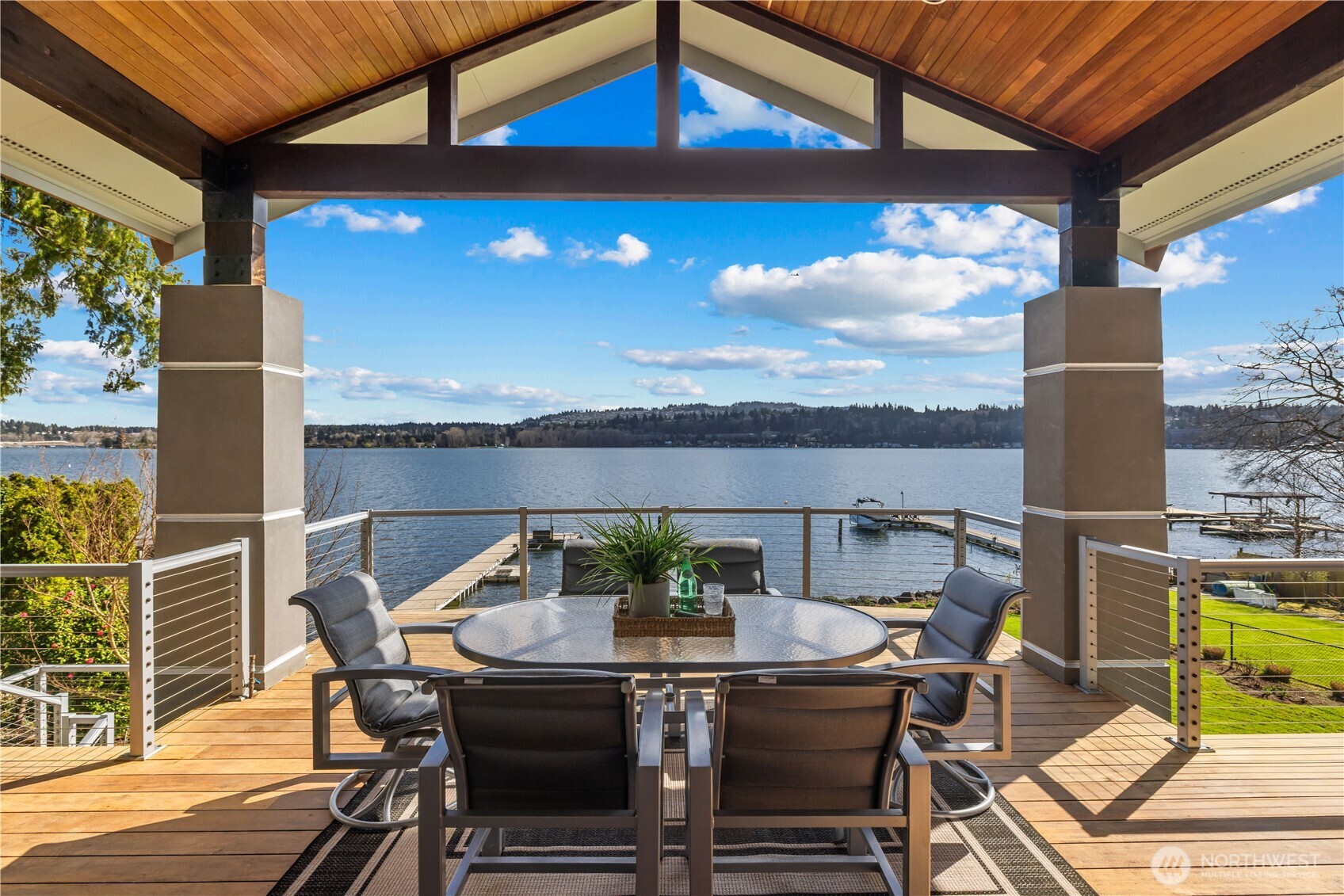 Covered waterfront deck designed for year-round living—dining, relaxing, and taking in uninterrupted lake views.