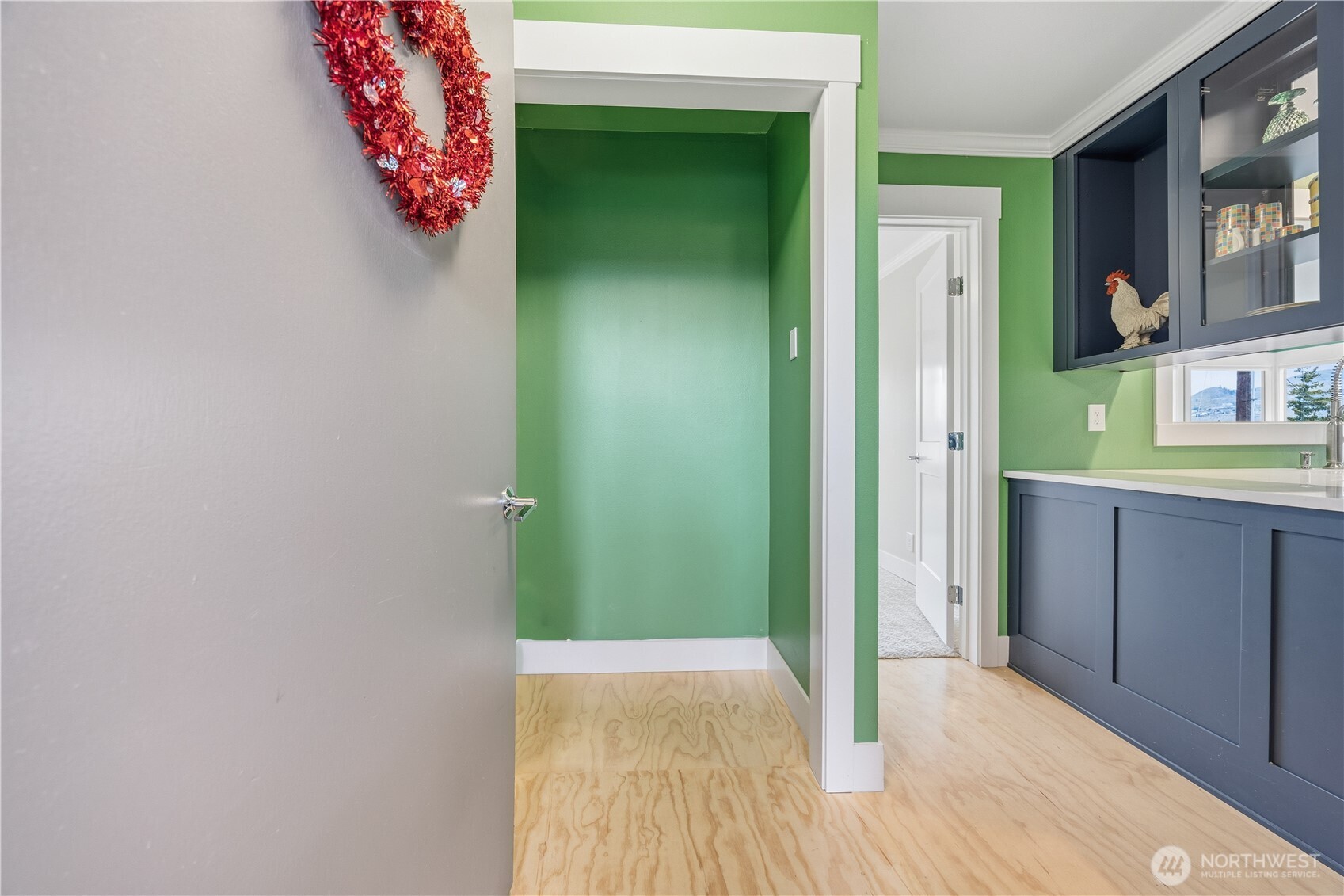 The front door entrance with coat closet directly in front and the kitchen and hallway opposite.