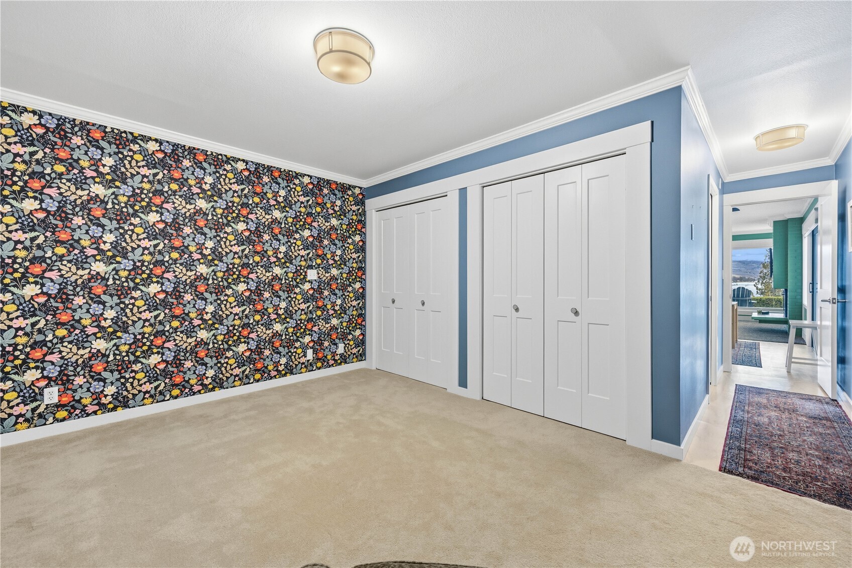 Main bedroom looking down the hall to ensuite on left and living area straight ahead.