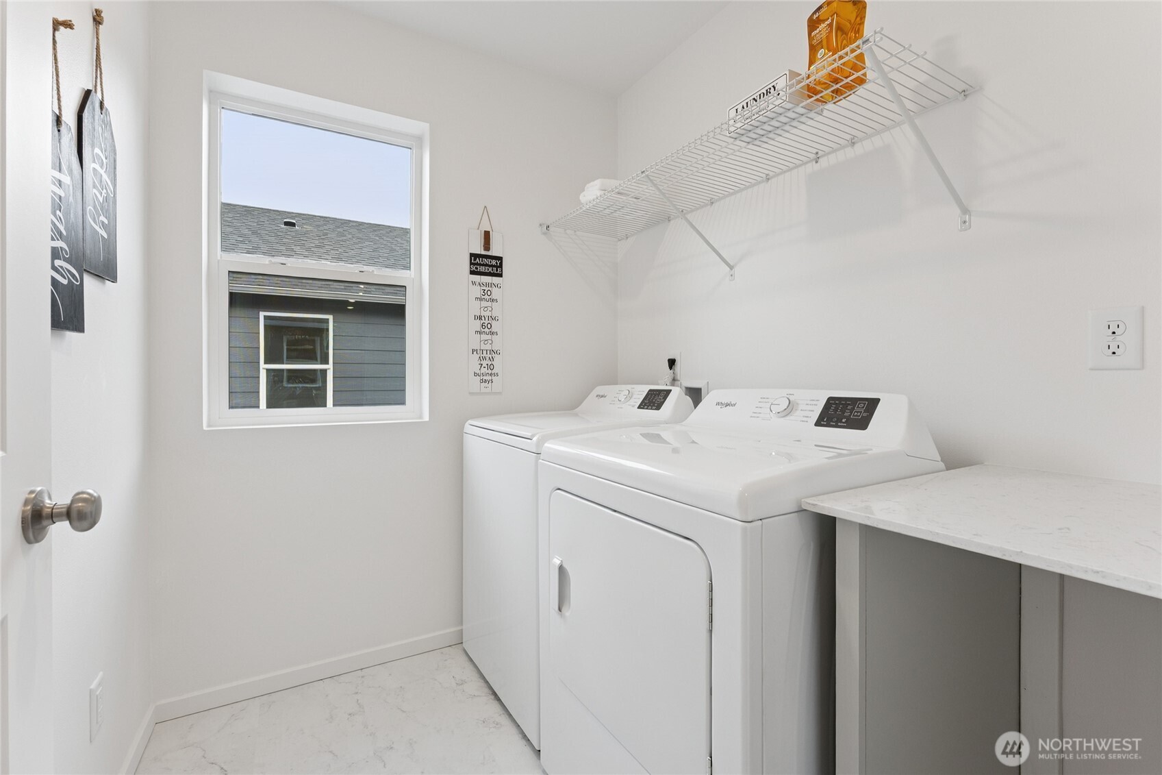 Upstairs laundry room with folding table.  Pictures are for representational purposes only, colors and features may vary.