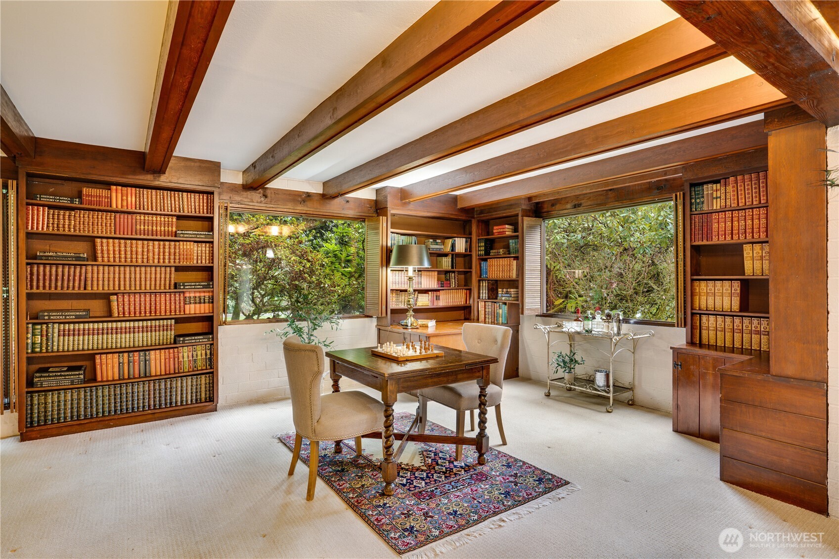 This is the other end of the family room with creek views & more built ins.