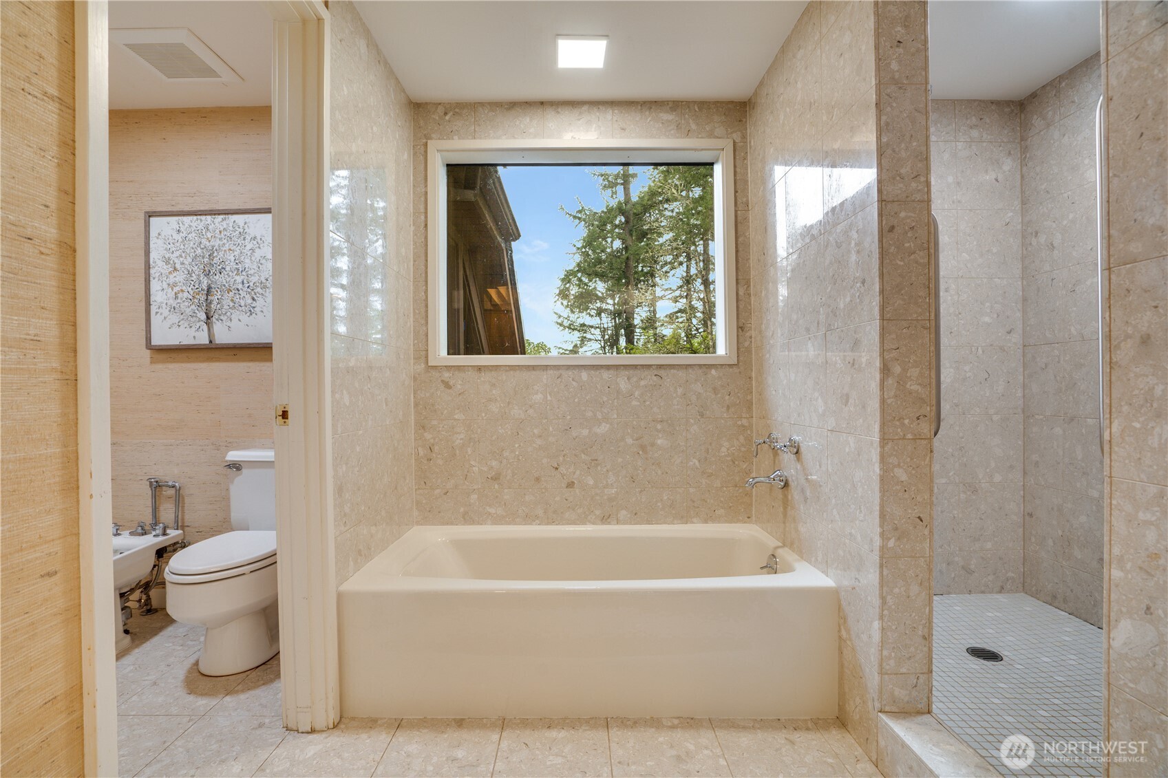 Stone wrapped walk in shower, soaking tub & private room with bidet.