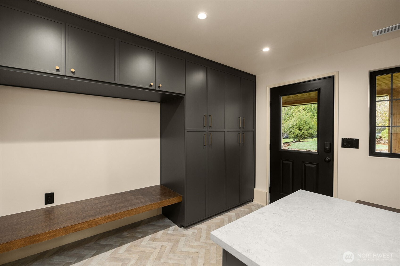 Mud room with plenty of storage, off the garage