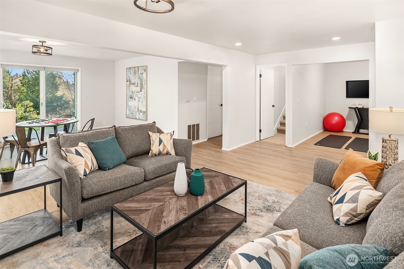 The light and bright lower level rec room features a woodburning fireplace and all new flooring.