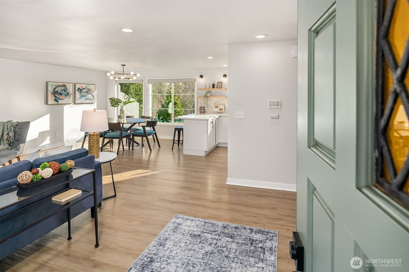 Large bay window and wood burning fireplace add charm and warmth to the living room.