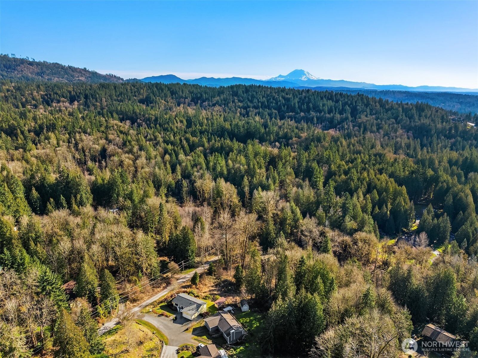 Stunning Tiger Mountain setting with the home in the foreground and Mt Rainier in the background.