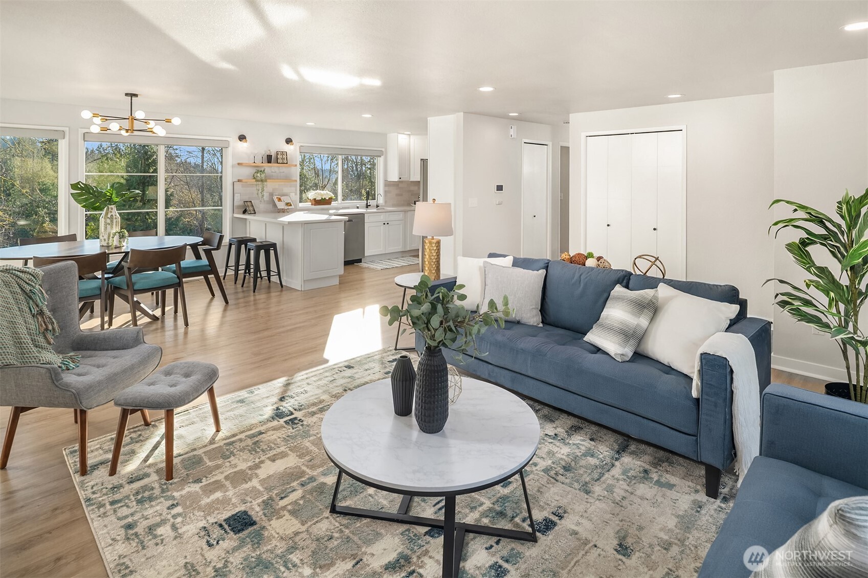 View towards the hallway leading to the primary BR, second BR/office, garage access, & staircase to the lower level.