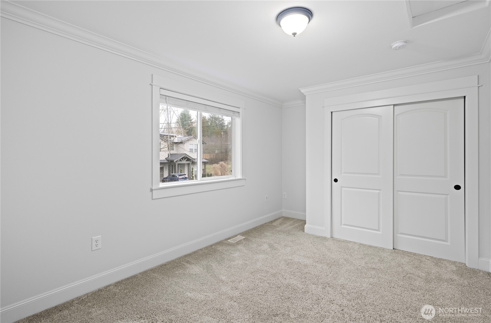 One of two additional bedrooms on the main floor with views to the front of the house.