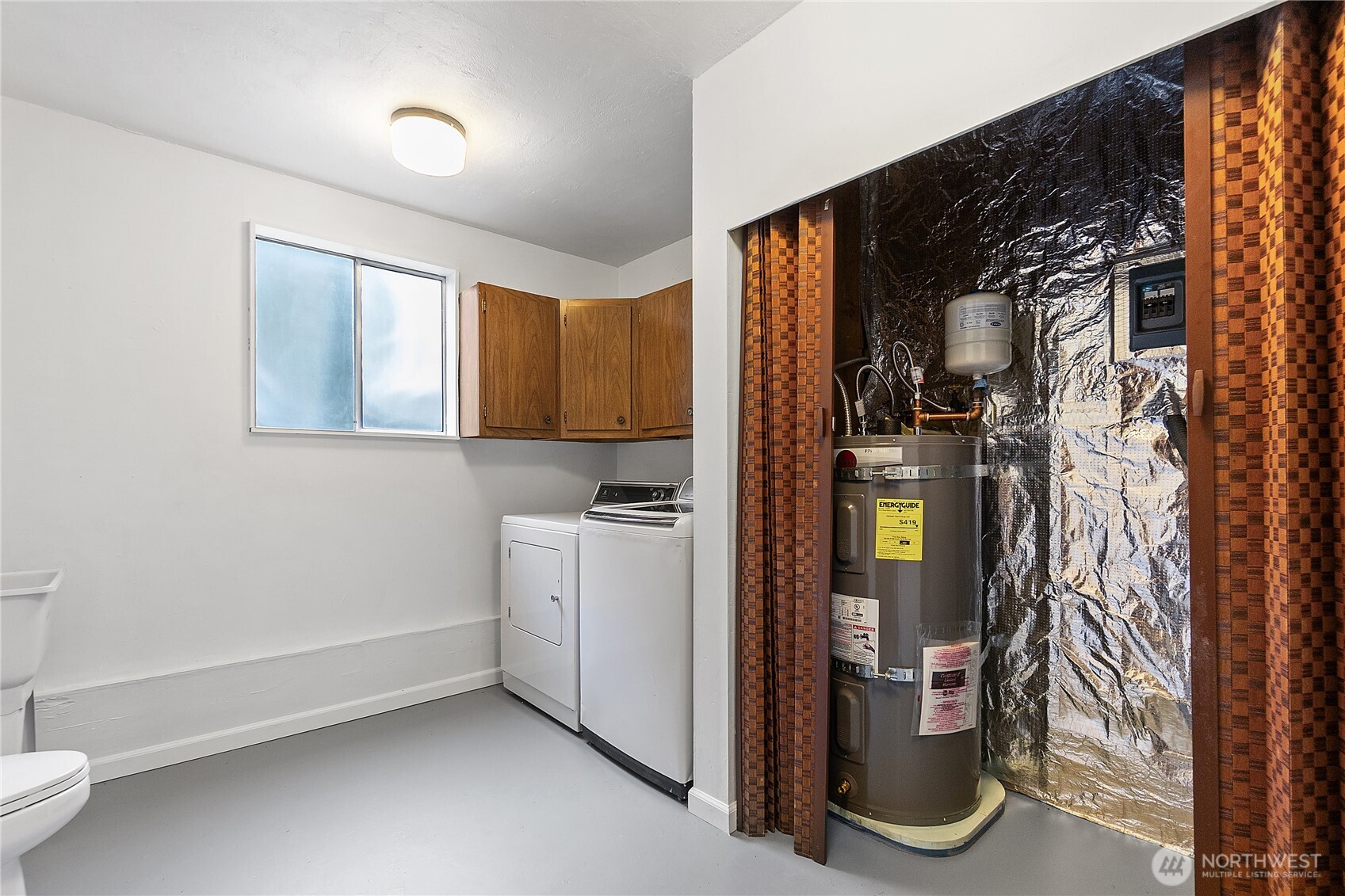 Downstairs laundry room with toilet and utility sink