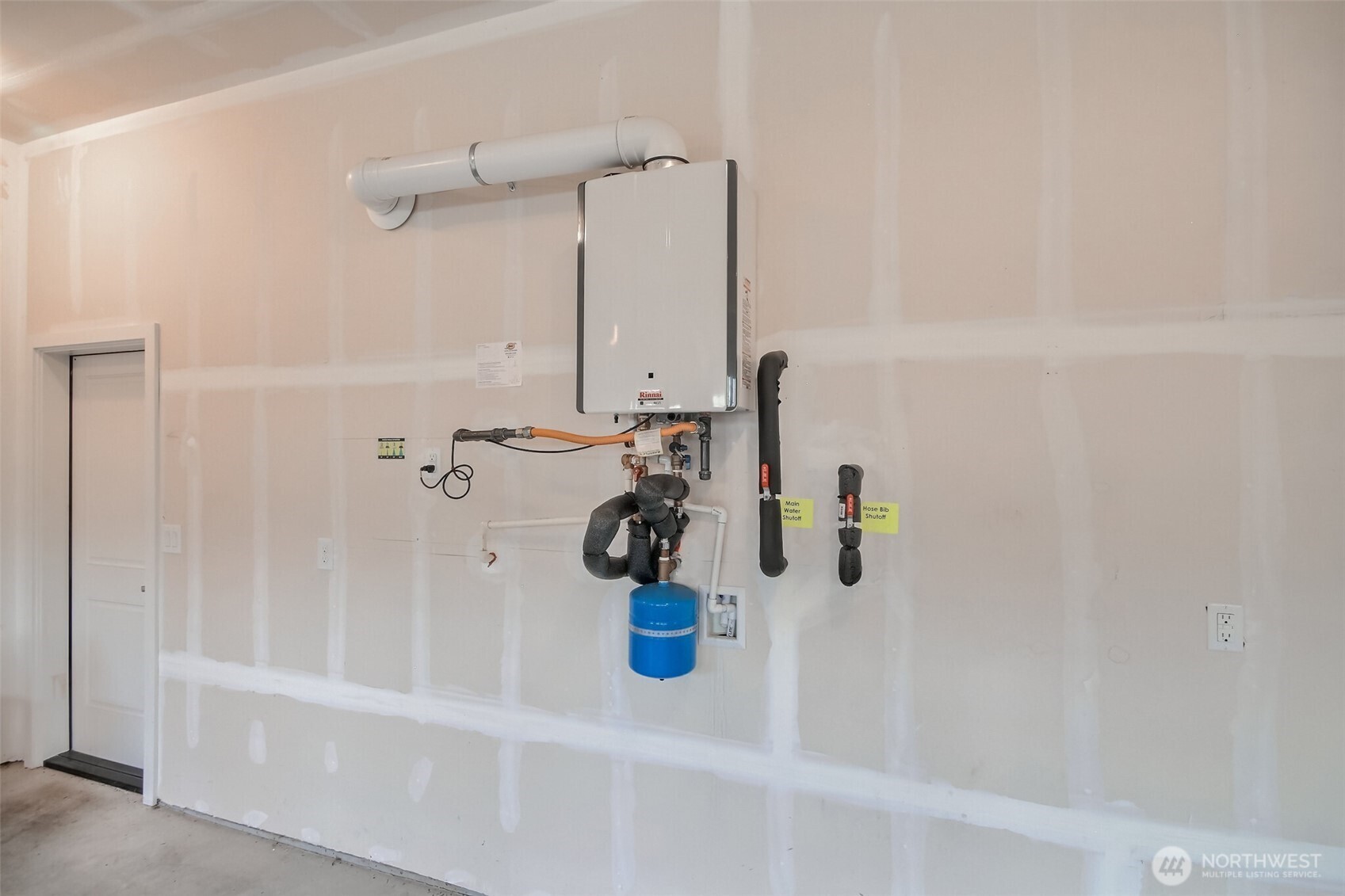 3 car garage has Tankless WH and mandoor to the backyard