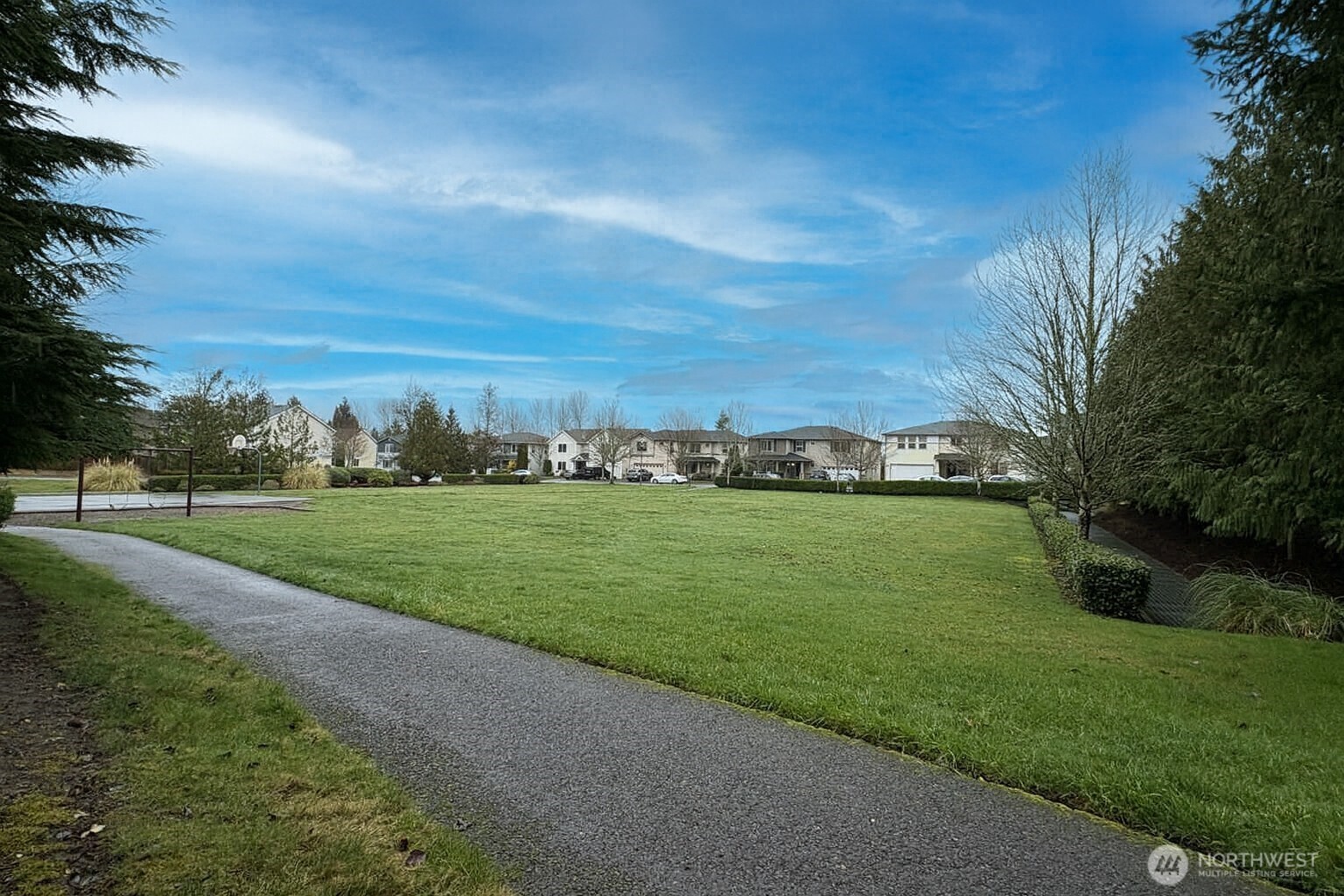 Large park with open space, playground and sport court