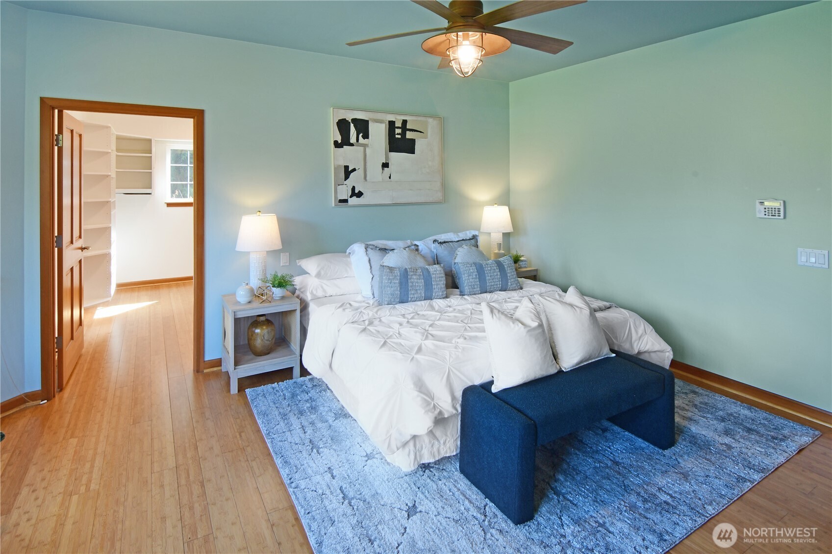 Well-appointed primary bath with clean finishes, easy-access layout, and luxurious heated floors.