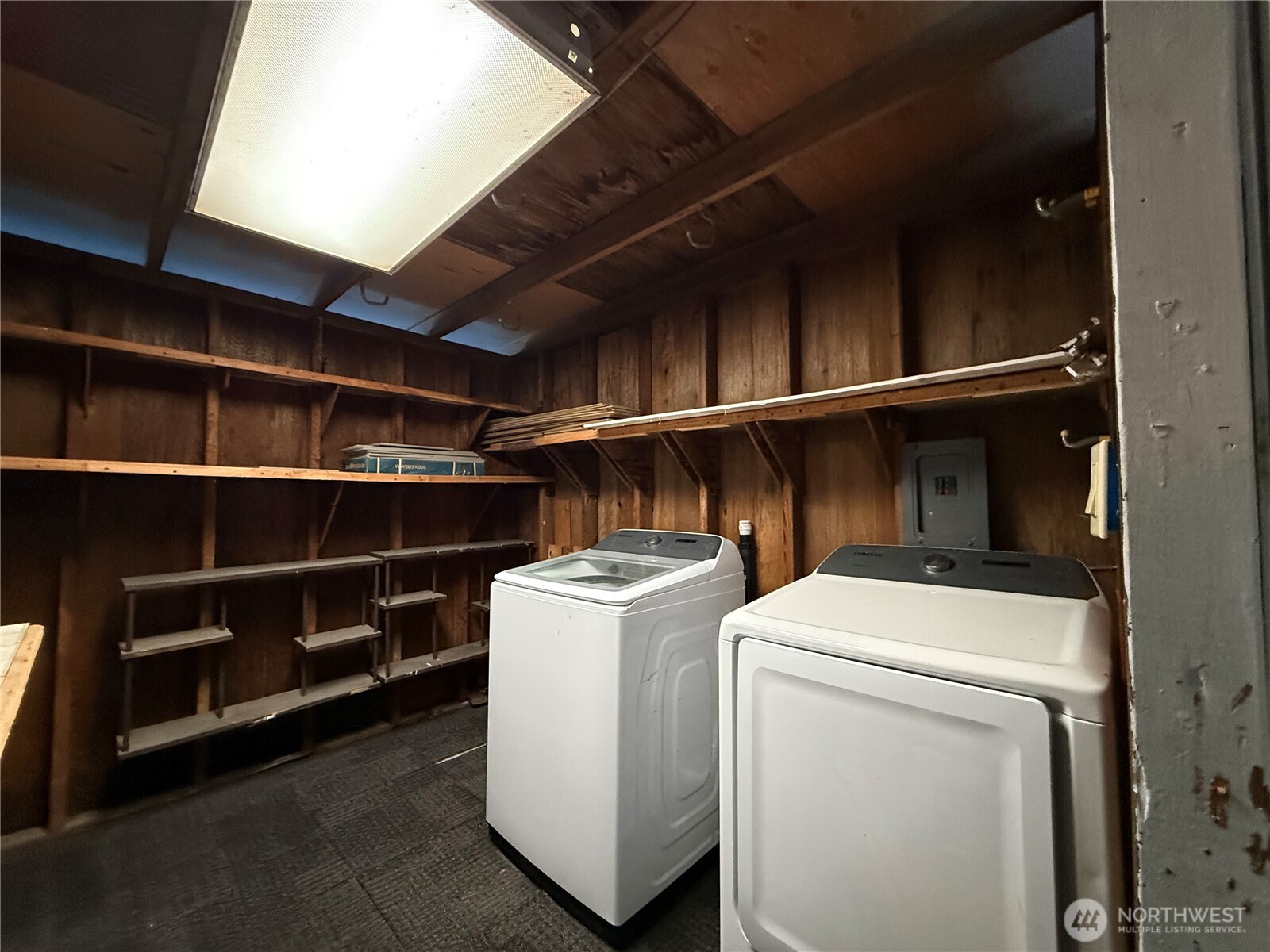 Storage room connected to Carport has Washer and Dryer