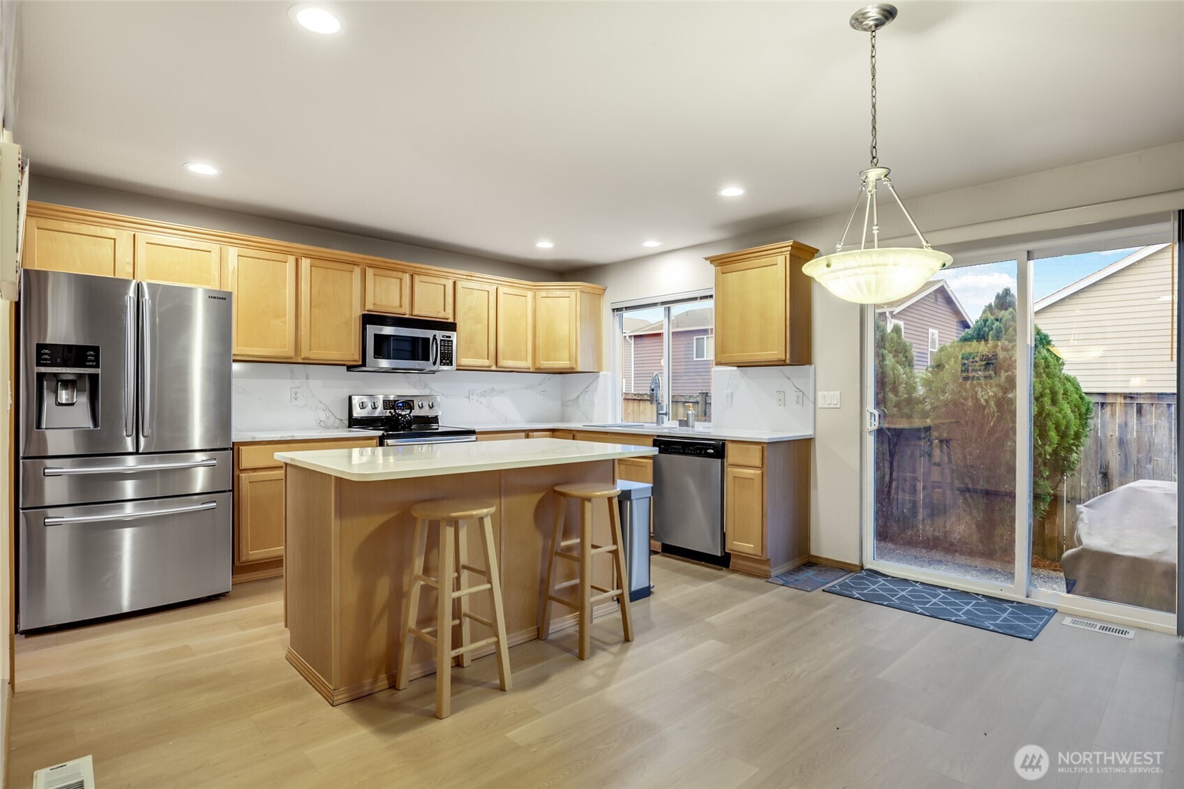 Slab countertops and newer SS appliances.