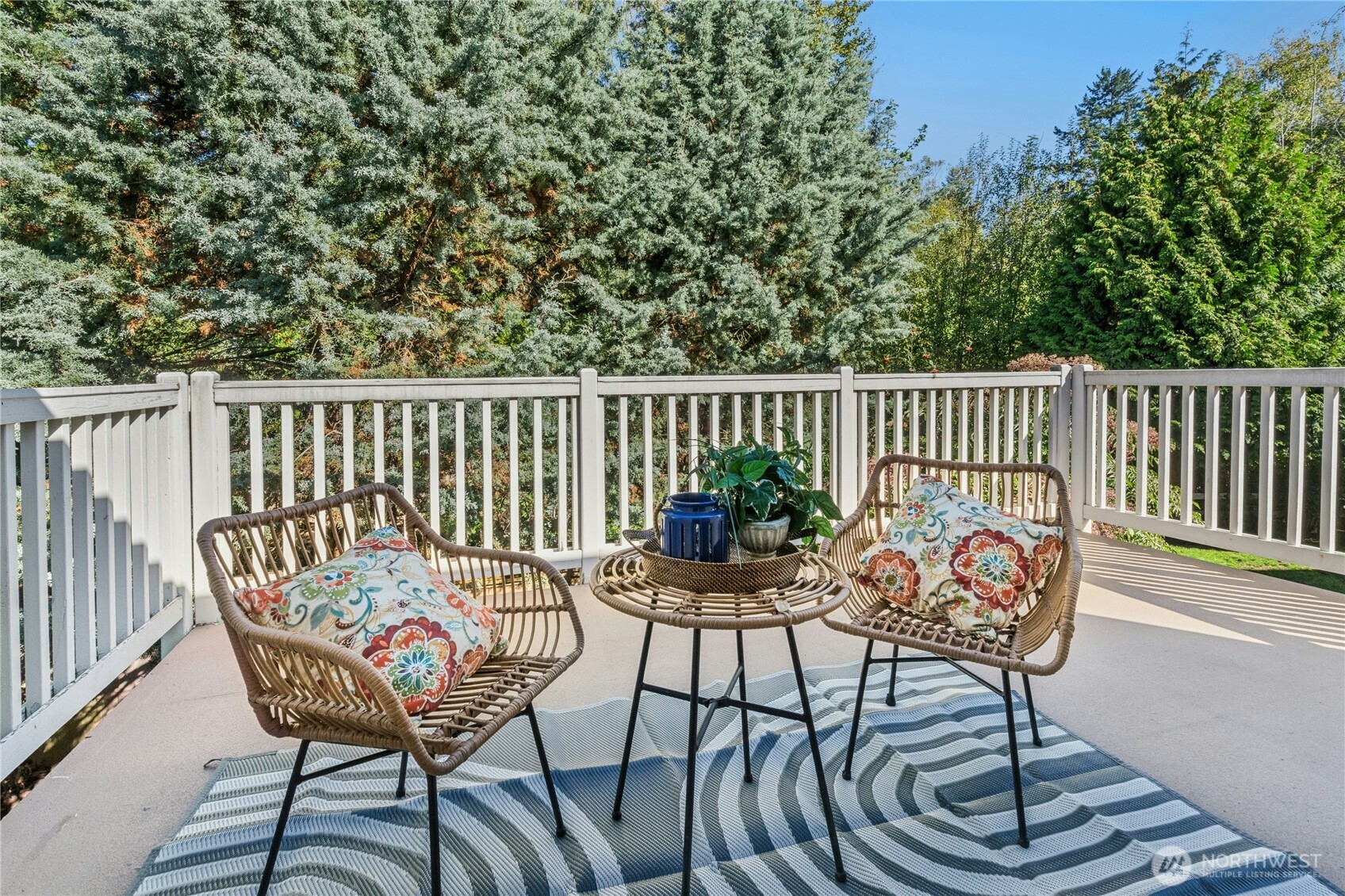 step out to spacious deck surrounded by trees.