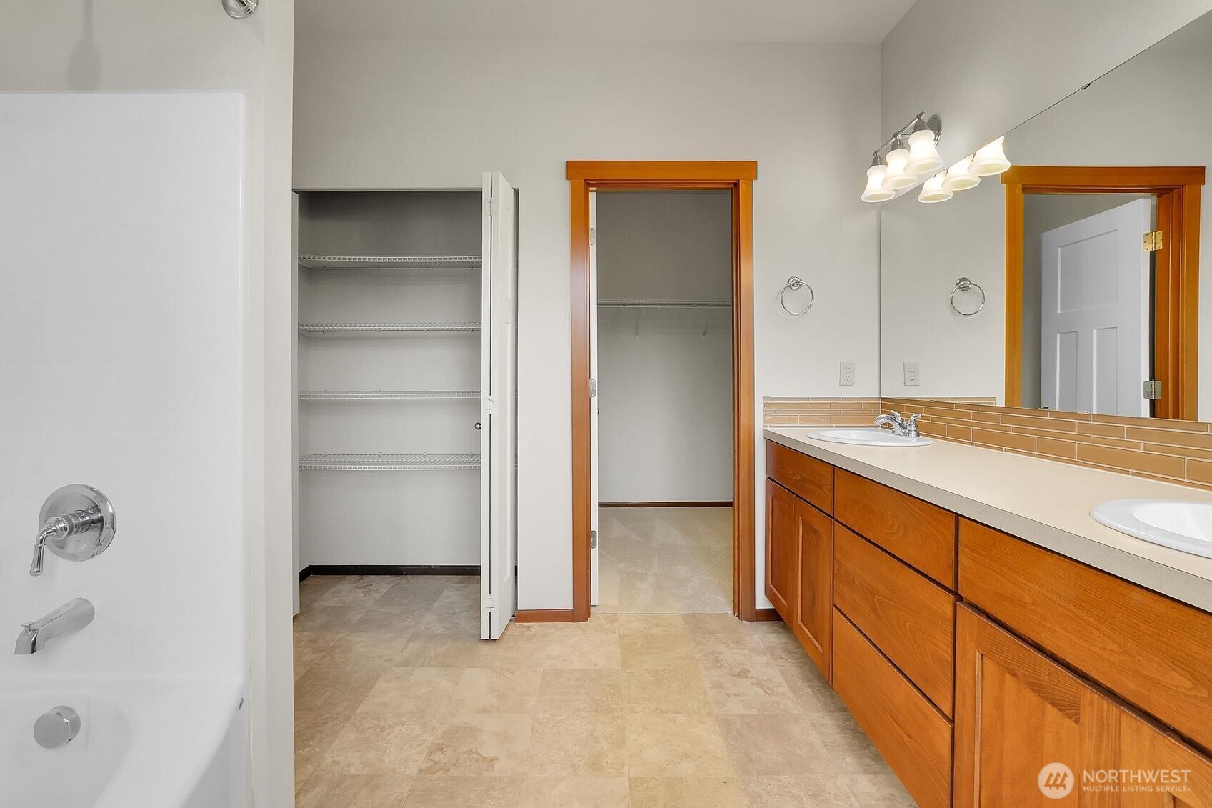 Large linen closet and walk-in closet in the primary bath.