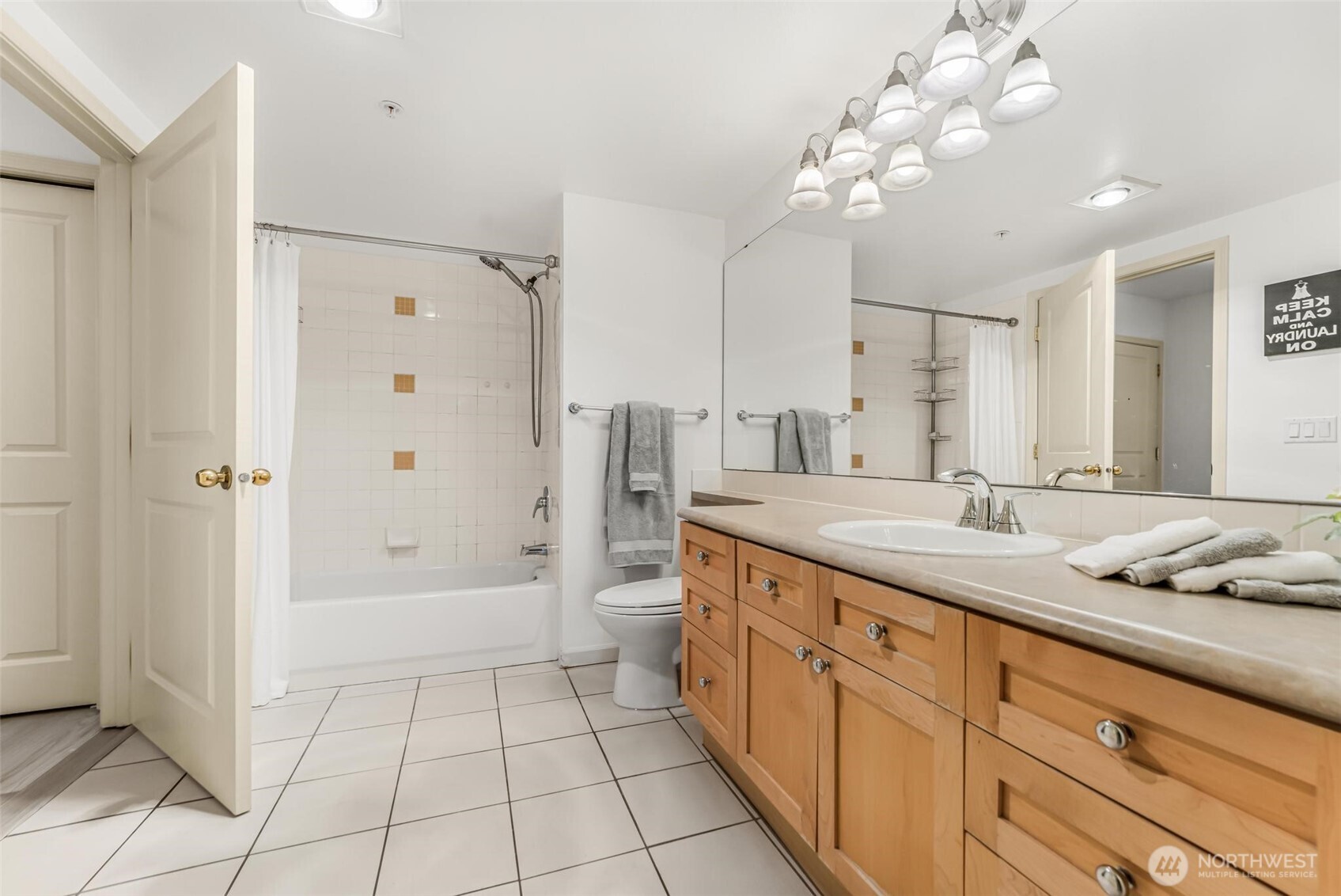 Full sized Washer/Dryer are located in a closet in this bathroom