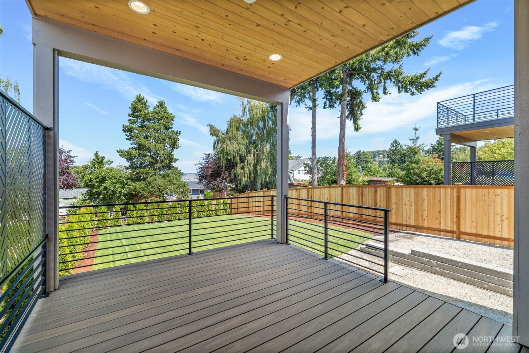 Main level deck off dining room & overlooking beautiful landscaping.