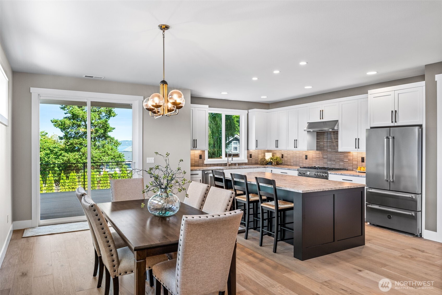 Partial water view from the dining room & from the kitchen...making clean up a little more enjoyable!  Expansive dining area would easily allow for a table for 10 or 12