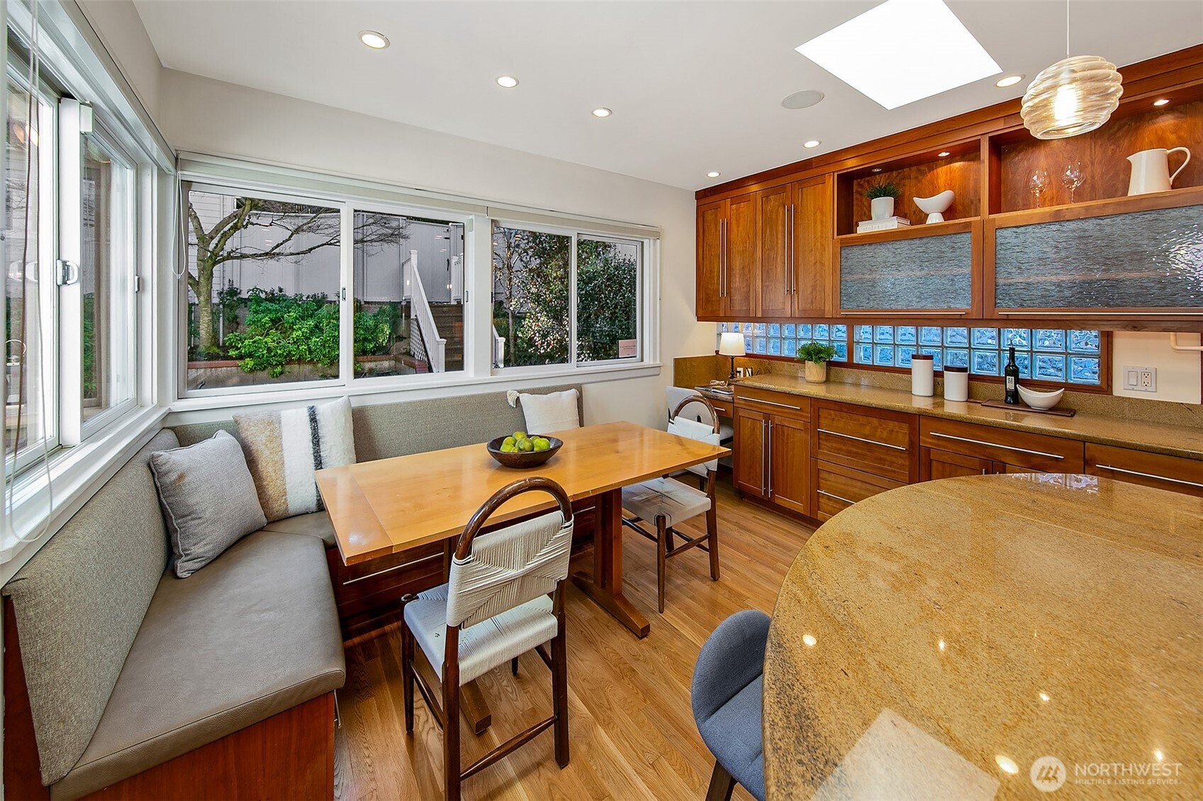 Right off the kitchen is the sunny, lush backyard.