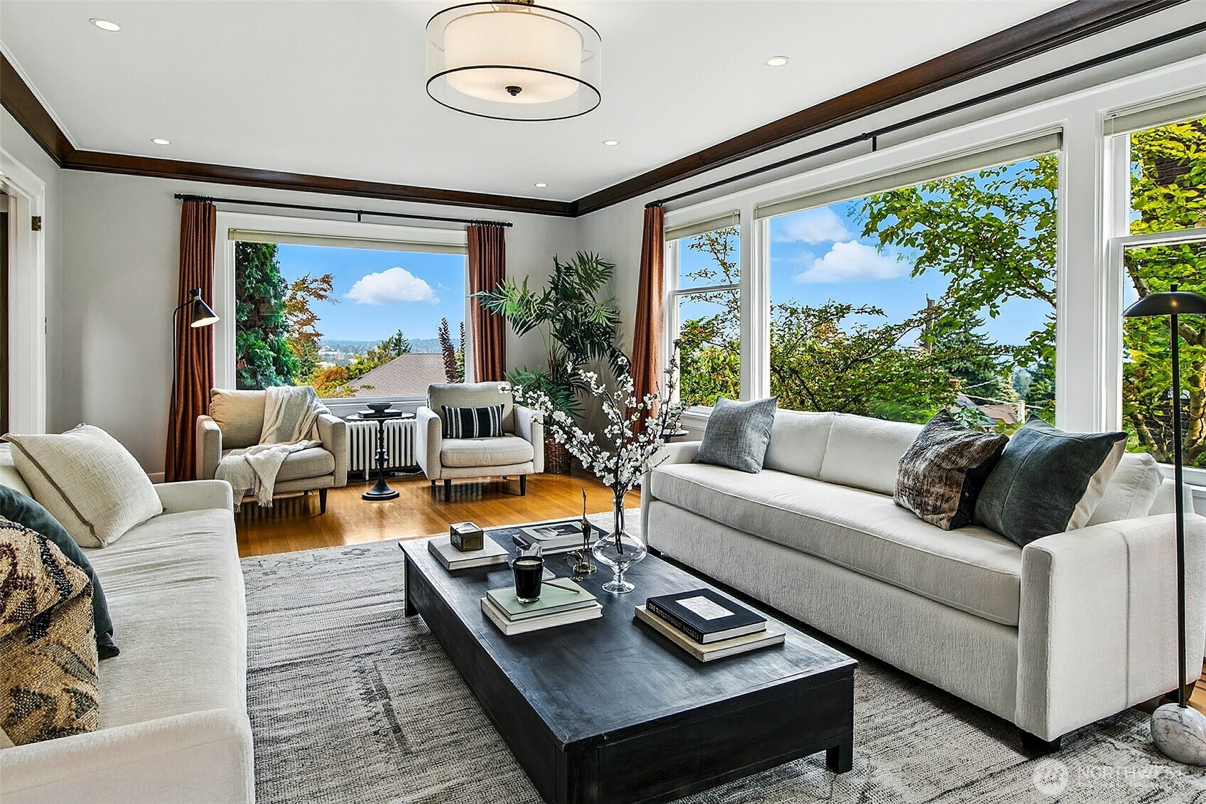 The original tile fireplace gracefully framed with glass bookshelves.