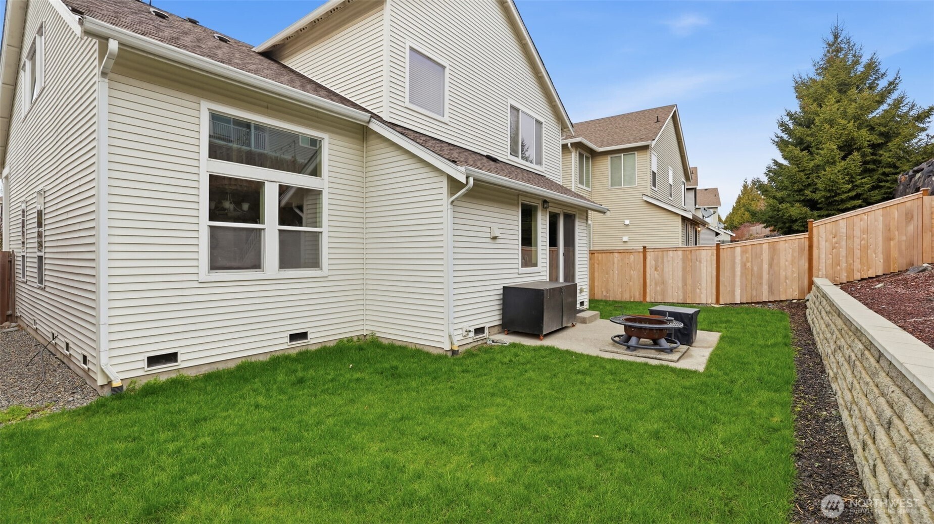 Relax or entertain with ease on the patio, surrounded by a beautifully refreshed yard