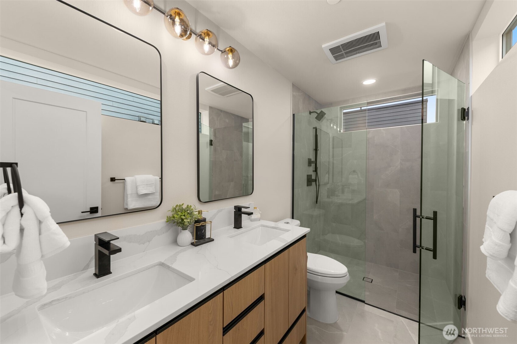 Luxury finishes fill the en-suite primary bath.