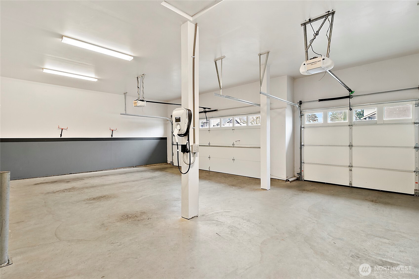 Three car garage equipped with a EV charger and updated garage doors.